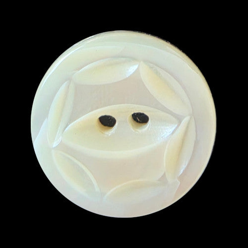 Carved freshwater shell button with fisheye design formed by six carved cuts outlining a hexagon around a recessed two-hole center.