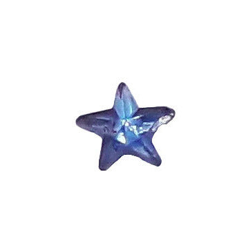 Tiny 5 mm sapphire mirrored glass star cabochon shown in close-up.