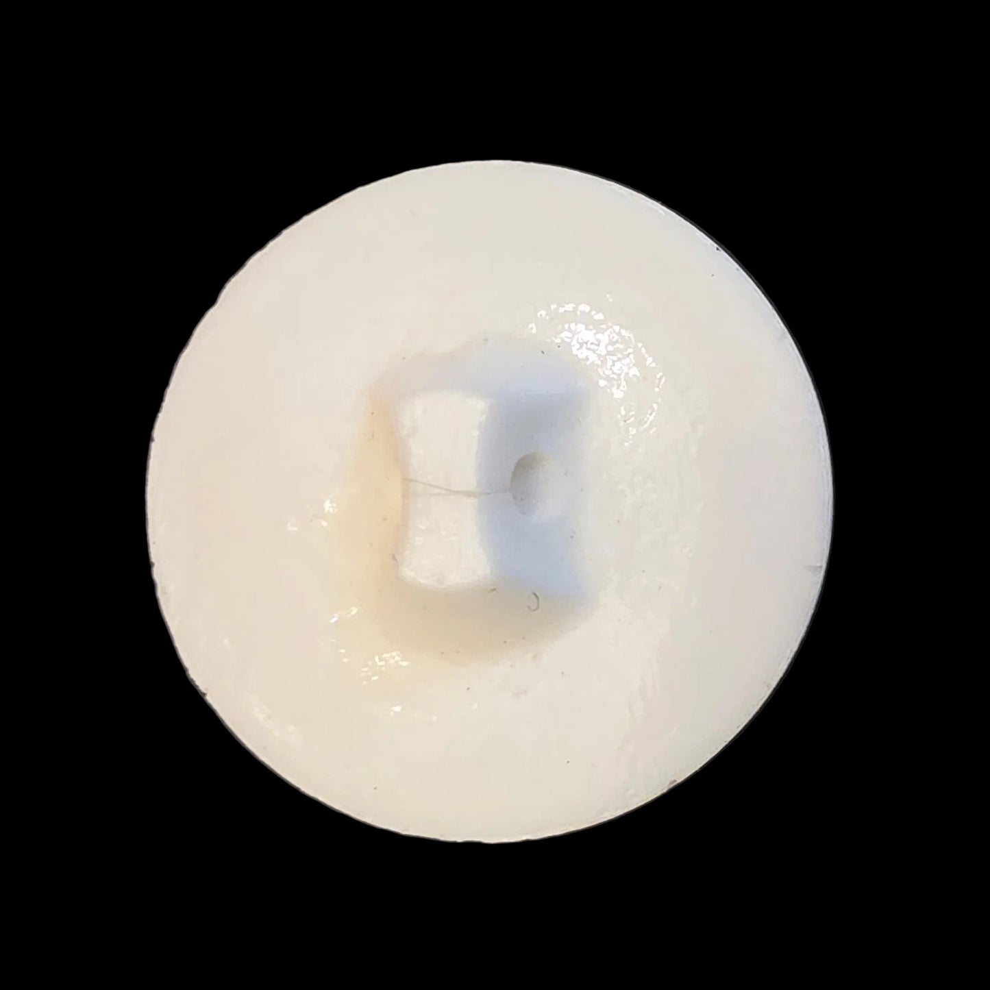 Back of white ribbed glass shank button.