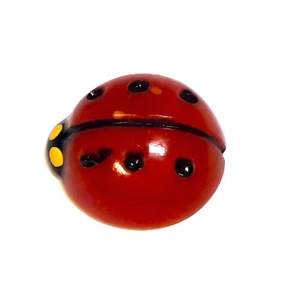 Hand-painted flat back of a red ladybug with black dots and yellow eyes on a white background.