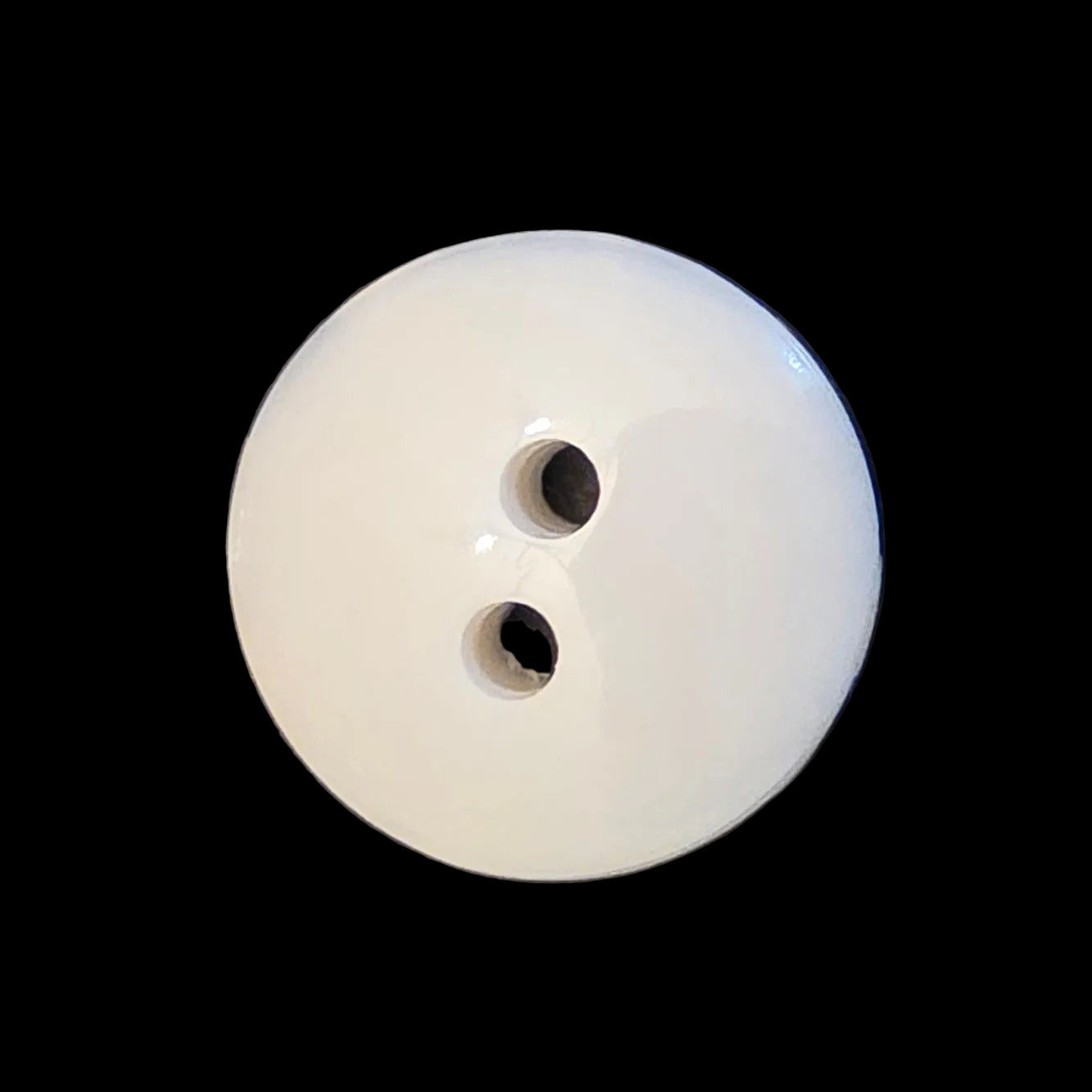 Back of a two-hole porcelain glass button.