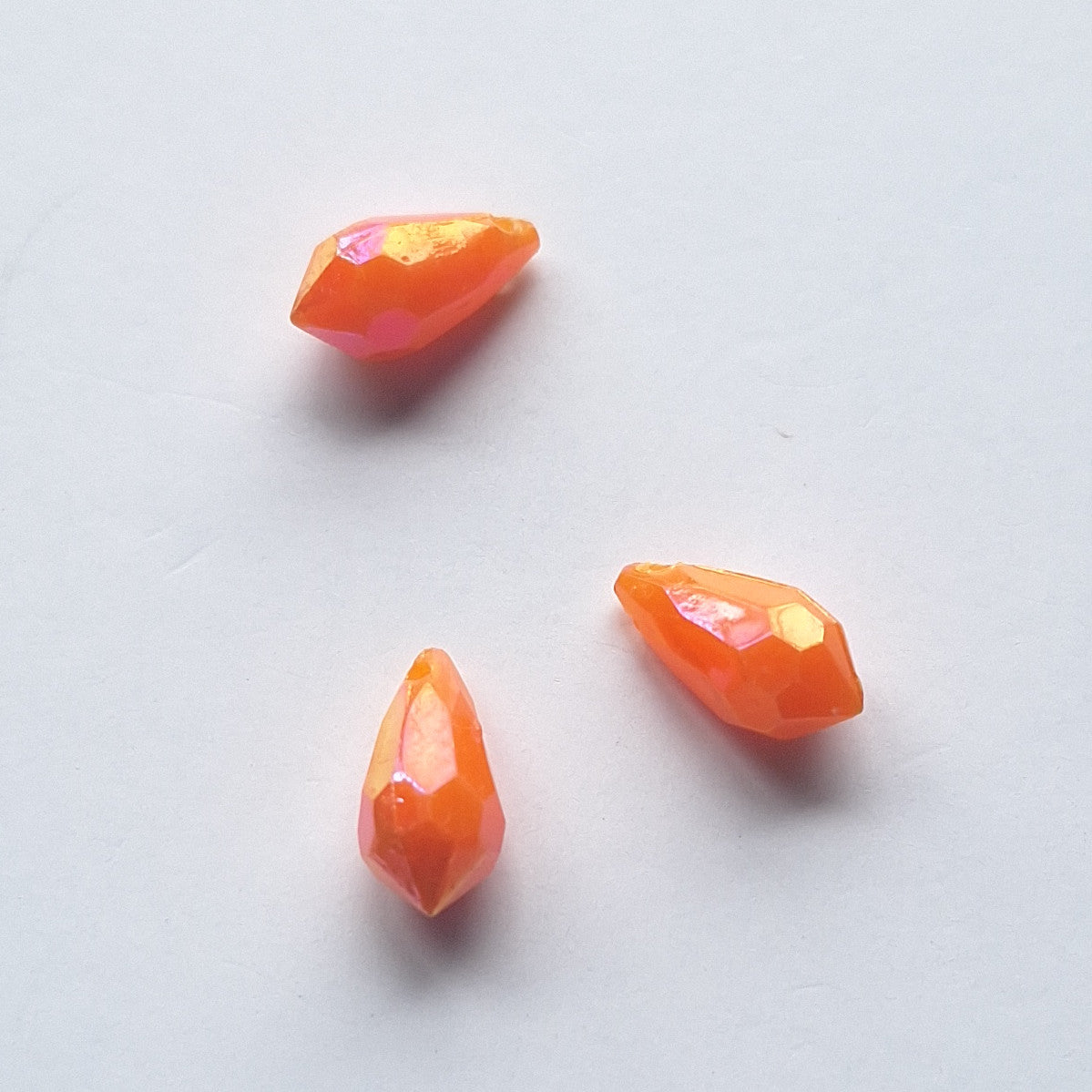 Three AB faceted plastic drop in Orange, opaque, sew-on, 6.5x13mm.