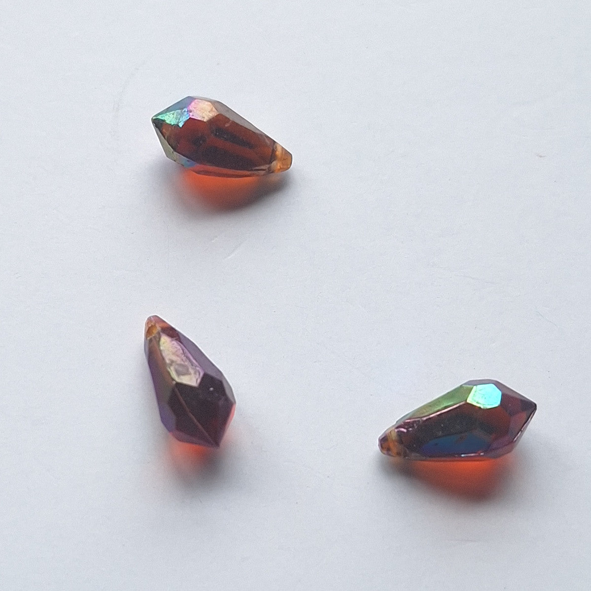 Three AB faceted plastic drop in Dark Amber, translucent, sew-on, 6.5x13mm.