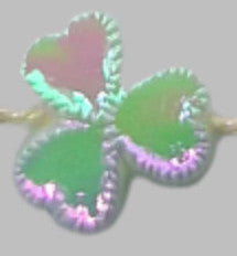 Close-up of a single AB plastic shamrock leaf showing heart-shaped form, raised serrated edge, and recessed center.