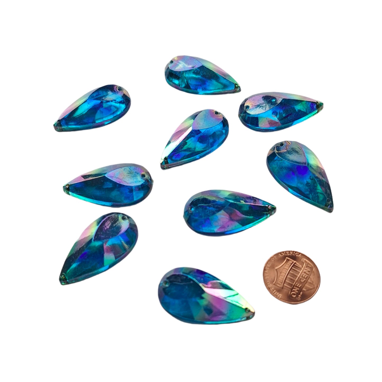 Sapphire AB teardrop cabochons shown together, with a penny for scale.