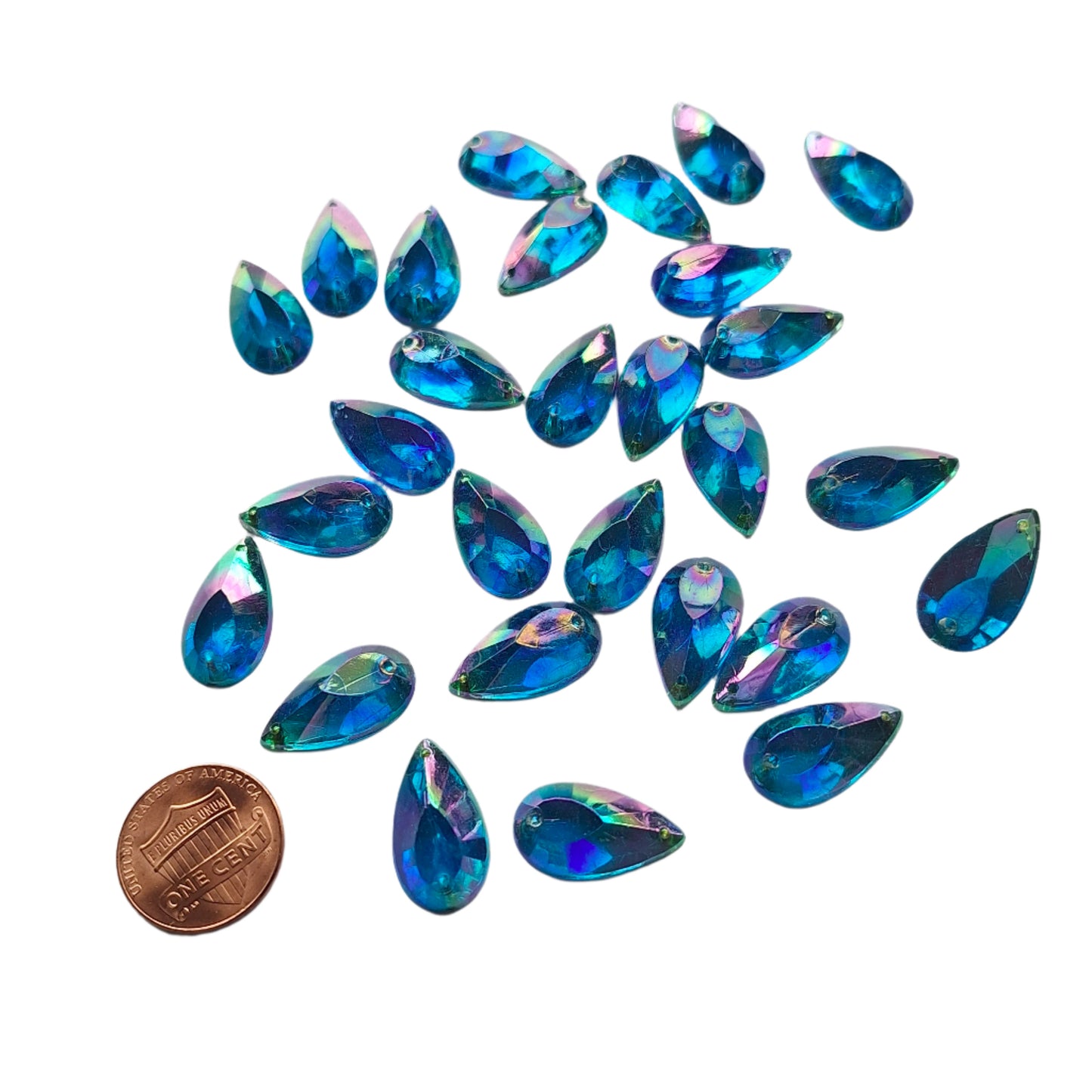 Sapphire AB teardrop cabochons shown in a group, with a penny for scale.