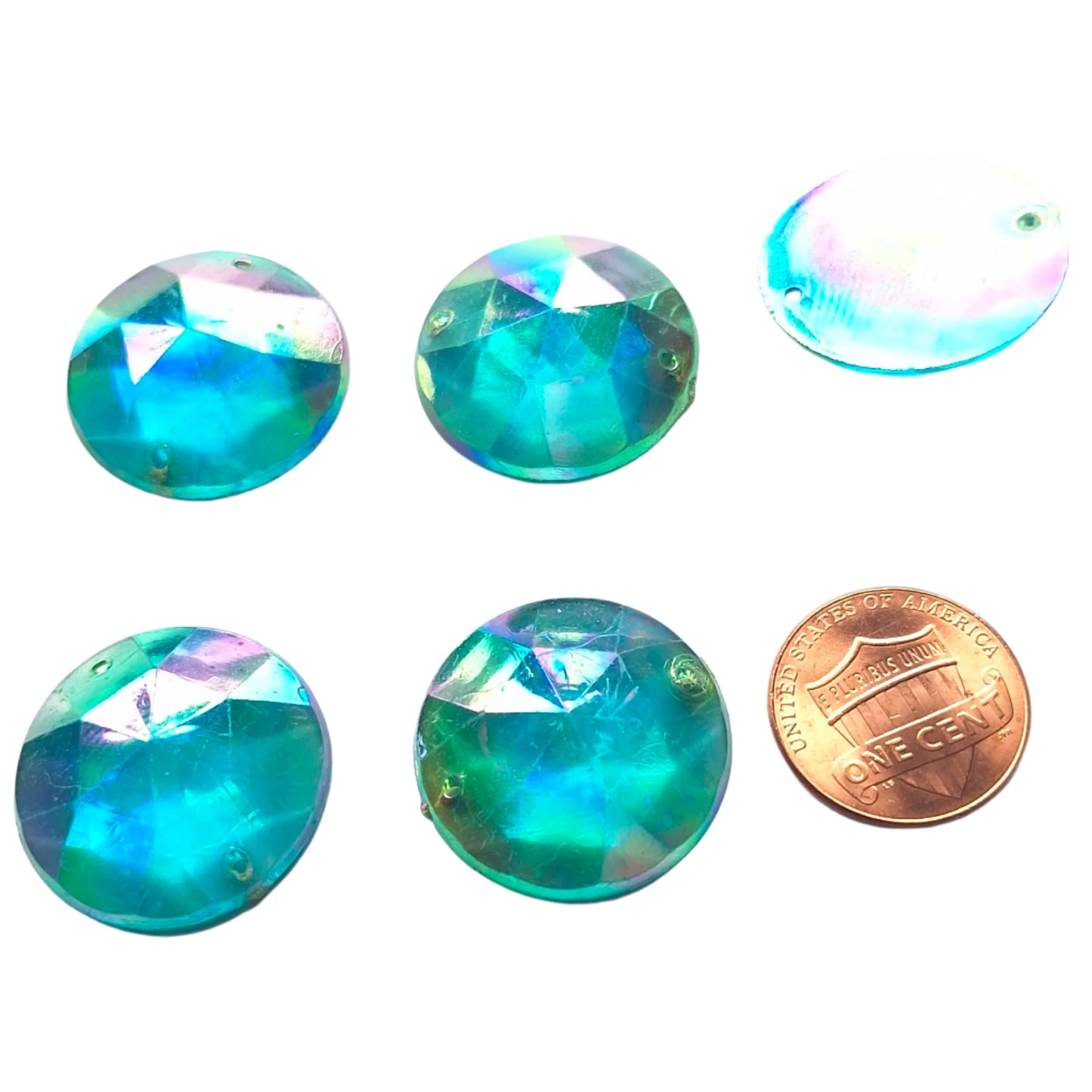 Aqua AB round faceted plastic cabochons arranged in a group of five, with one flipped to show the two-hole sew-on back; penny included for scale.