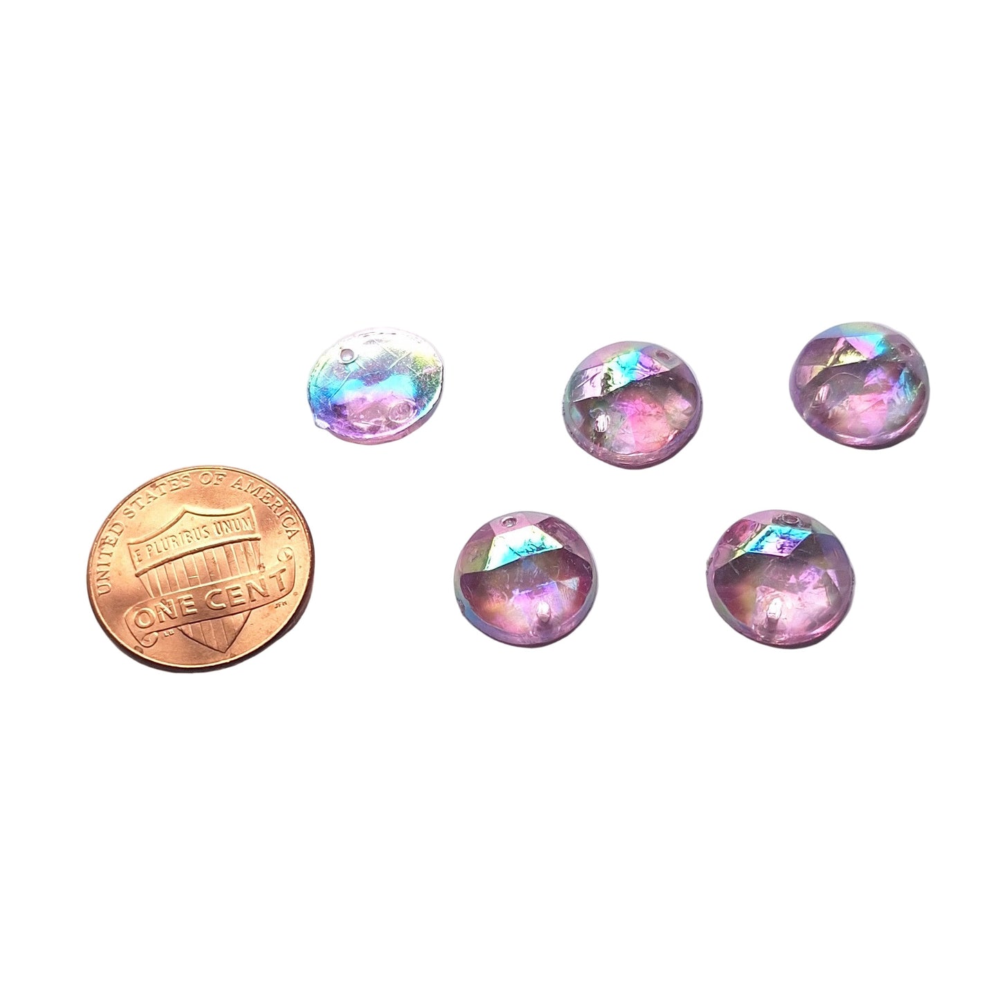 Amethyst AB round faceted cabochons arranged in a group of five, with one flipped to show the two-hole sew-on back; penny included for scale.