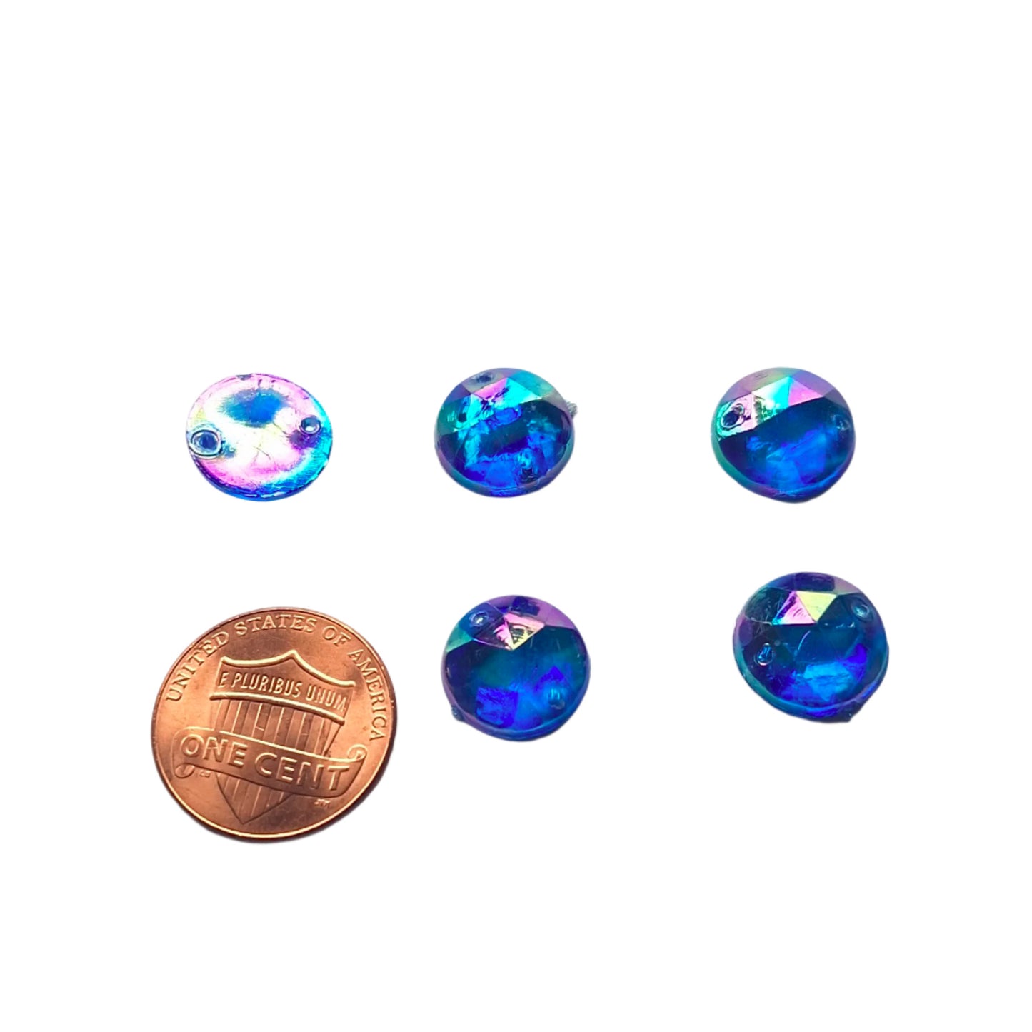 Sapphire AB round faceted cabochons arranged in a group of five, with one flipped to show the two-hole sew-on back; penny included for scale.