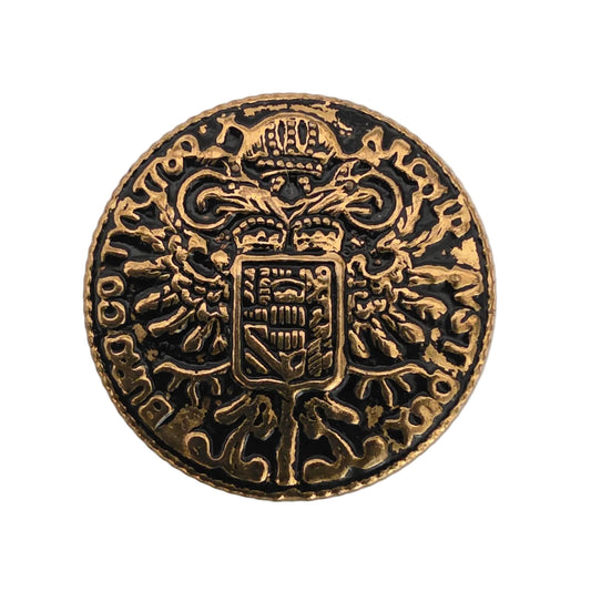 Stamped brass shank button with antique finish and Maria Theresa thaler-style heraldic coin design, 18mm.