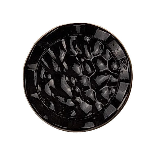 Black glass button with a hammered concave surface and recessed edge, showing strong depth and reflective texture.