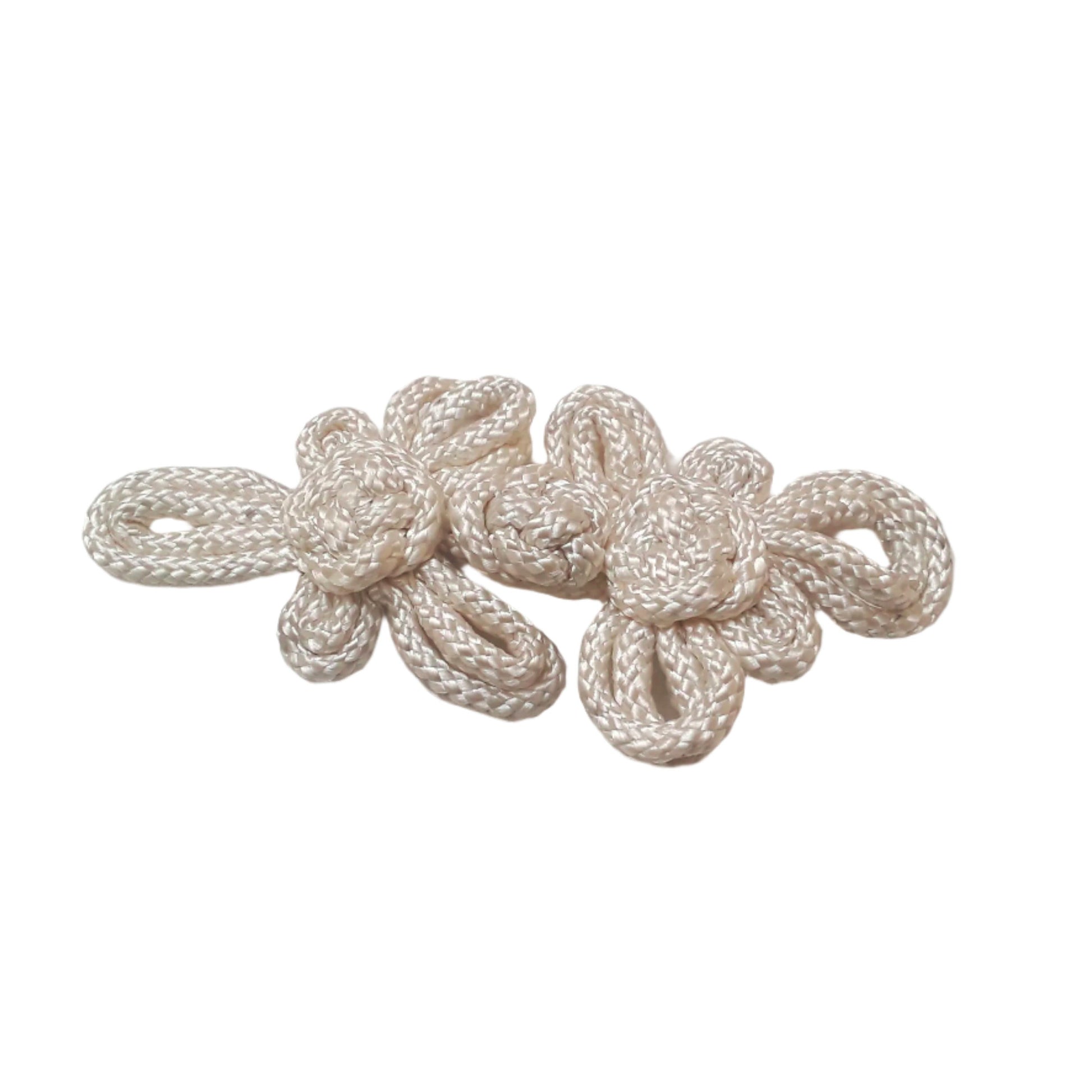 A large 140mm white pajama frog closure made from braided cord with twin knot motifs.