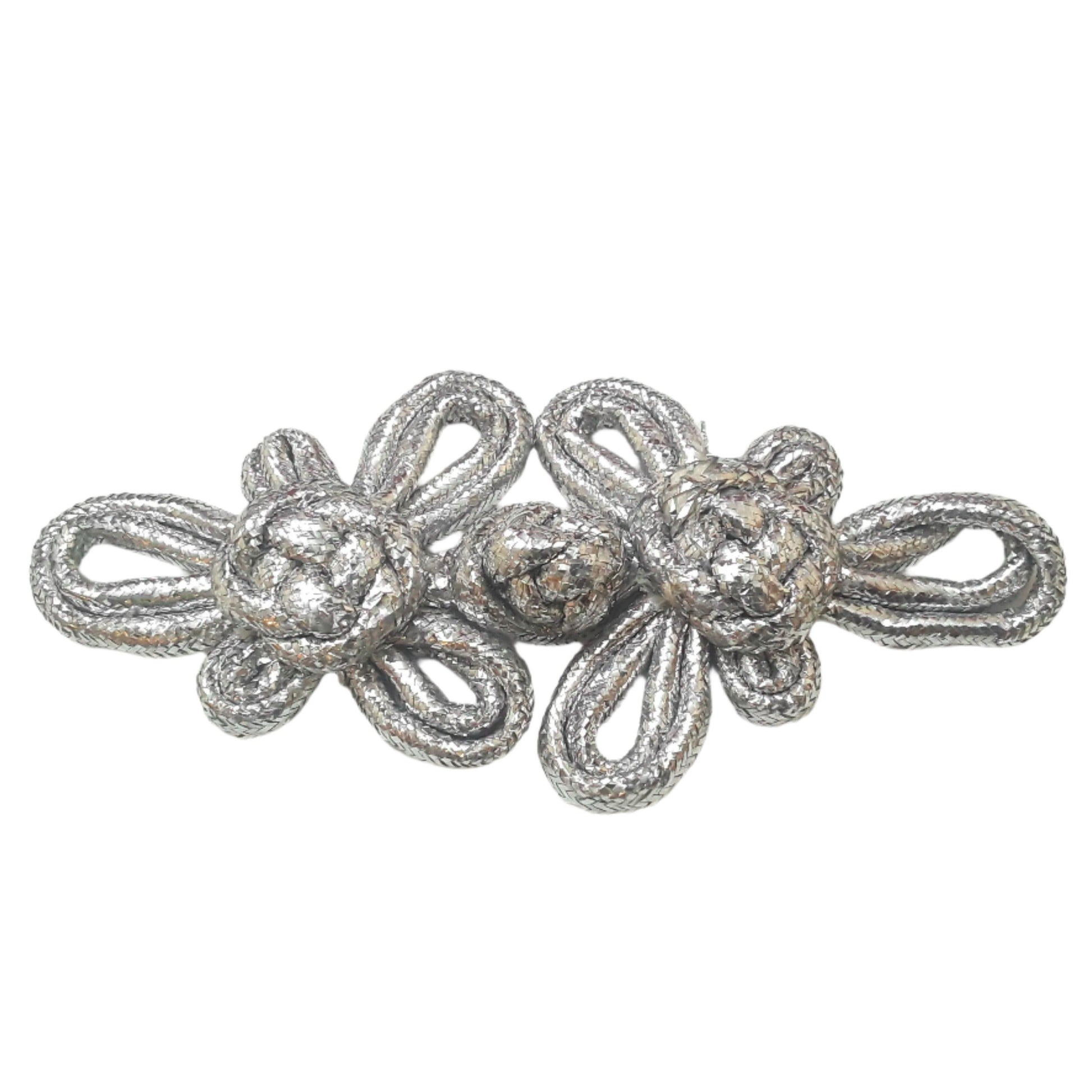 A large 140mm silver pajama frog closure made from braided cord with twin knot motifs.