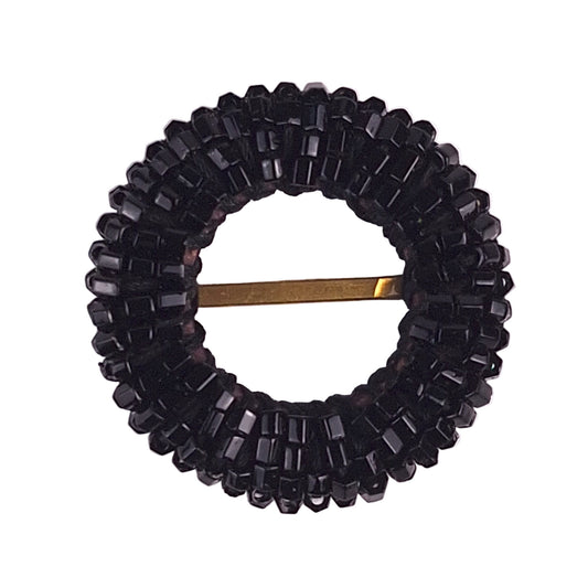Black buckle: Round jet black beaded buckle with densely sewn seed beads and a central brass bar.