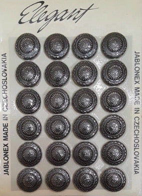Button card of 24 black glass buttons with a raised crest design and silver molded detailing, 18mm/28L.
