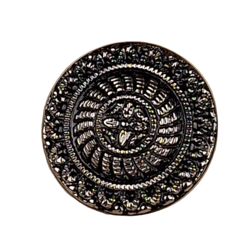 Black glass button with a raised crest design and silver molded detailing, 18mm/28L.