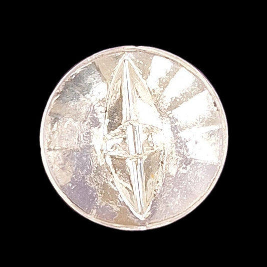 Clear glass button with a raised geometric starburst design and faceted surface, 14mm/22L.