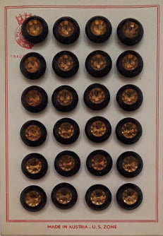 Button card of 24 jet and gold glass buttons with faceted central cavity