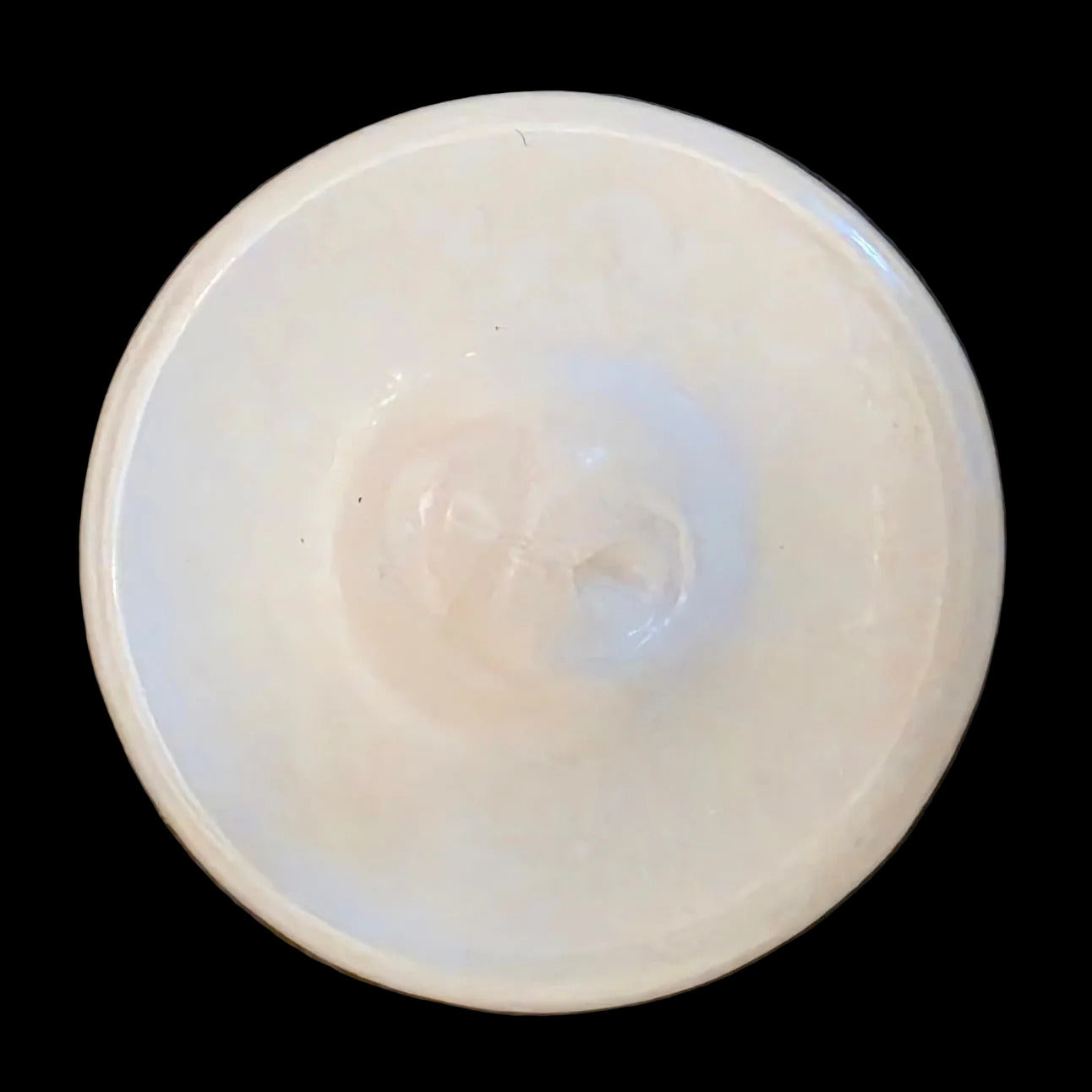 Back of white opaline glass button with raised diagonal line, shank back.