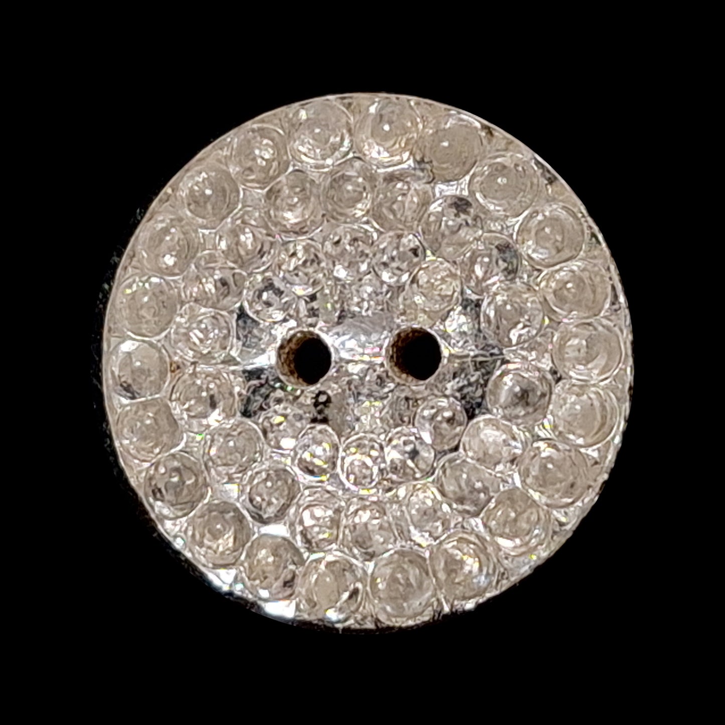 Mirrored glass button with a pebbled textured surface and two-hole sewing attachment, 19mm.