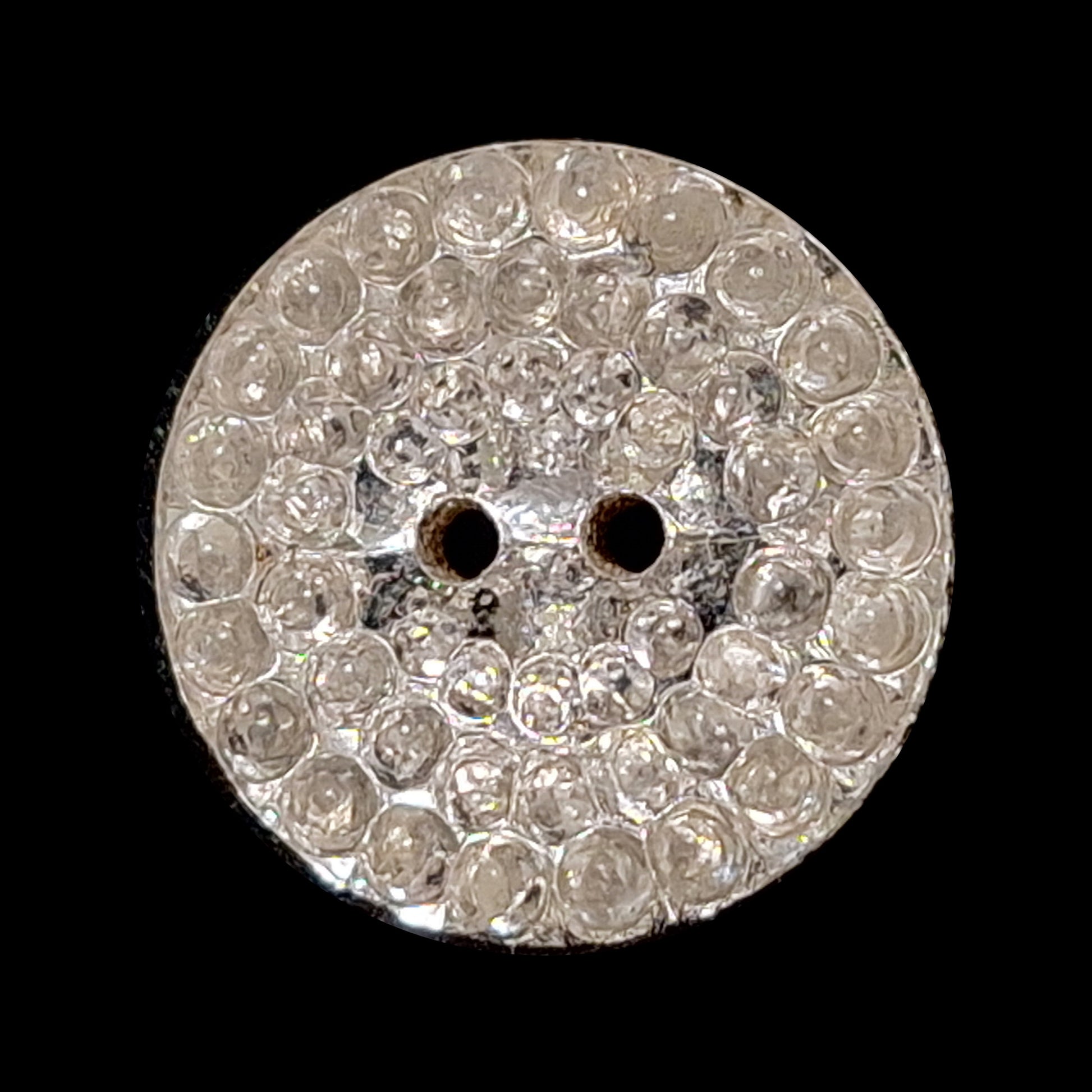Mirrored glass button with a pebbled textured surface and two-hole sewing attachment, 19mm.
