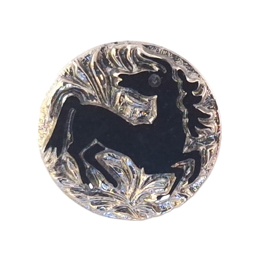 Black glass button with a rearing horse silhouette, framed by a raised clear molded border and decorative scrollwork, 18mm/28L.