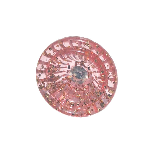 Pink tinsel plastic cup-shaped shank button with clear glass rhinestone center, 18mm.