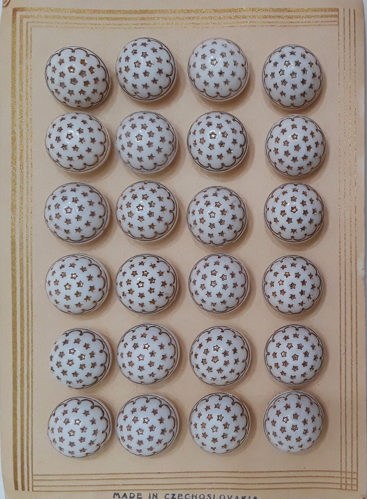 Button card of 24 white glass button with gold luster stars