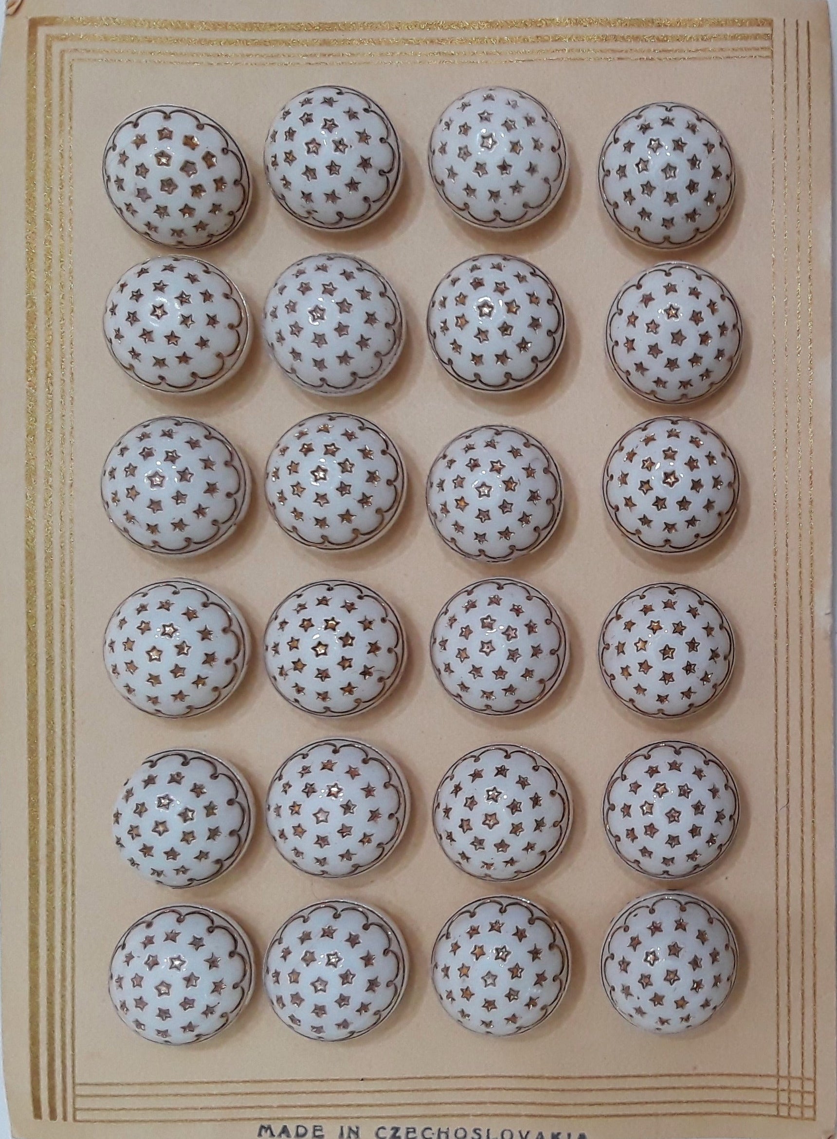 Button card of 24 white glass button with gold luster stars