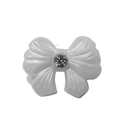 Pearl plastic bow button with molded bow shape and a central glass rhinestone, shown front view.