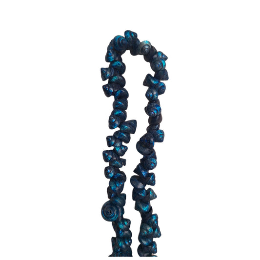 Blue strung seashells with hand-punched holes and natural 1/4-inch shells shown on strand segment.