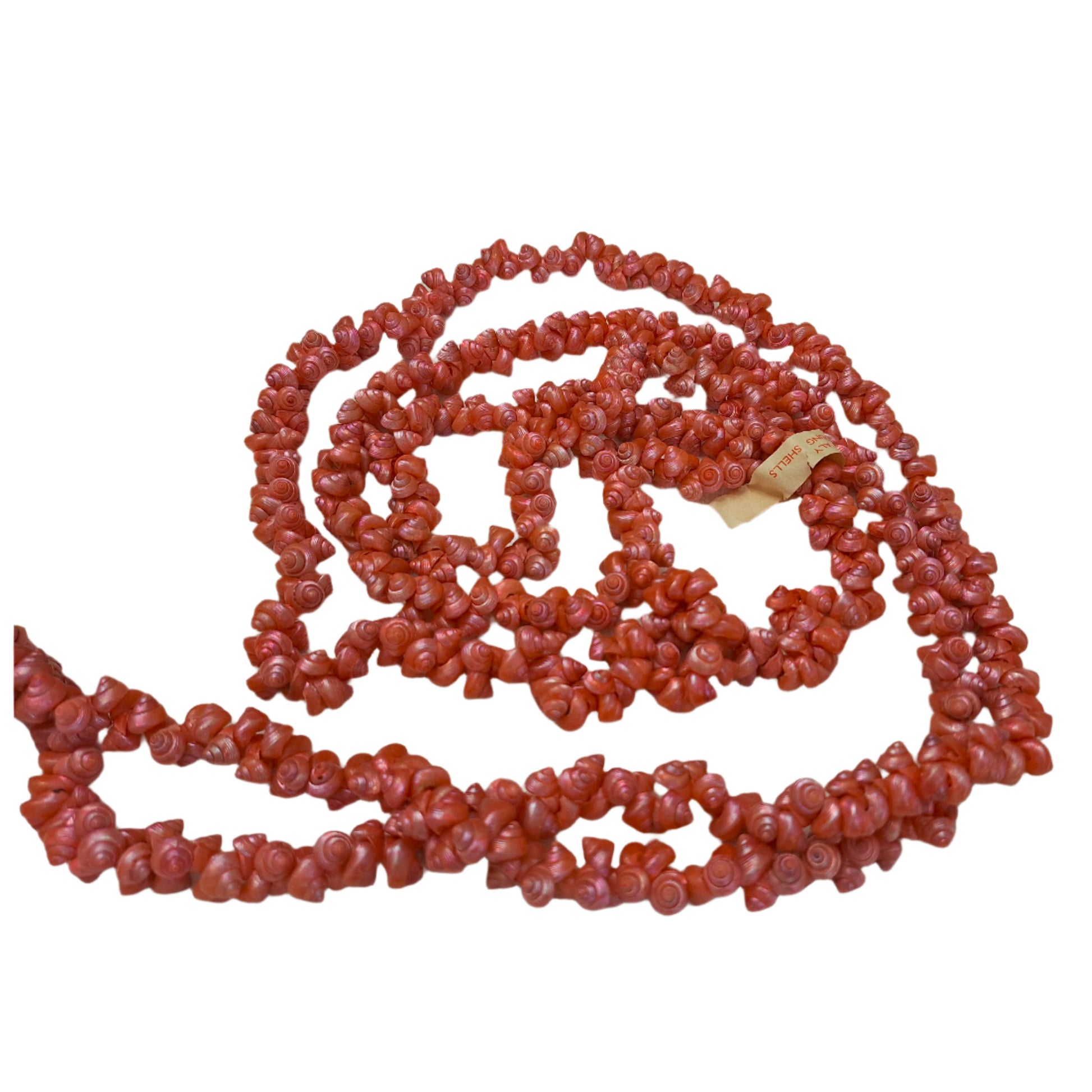 Dark pink strung seashells with hand-punched holes and natural 1/4-inch shells shown on complete strand with attached label.