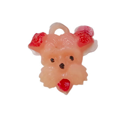 Hand-painted plastic flat back of a pink puppy face on a white background