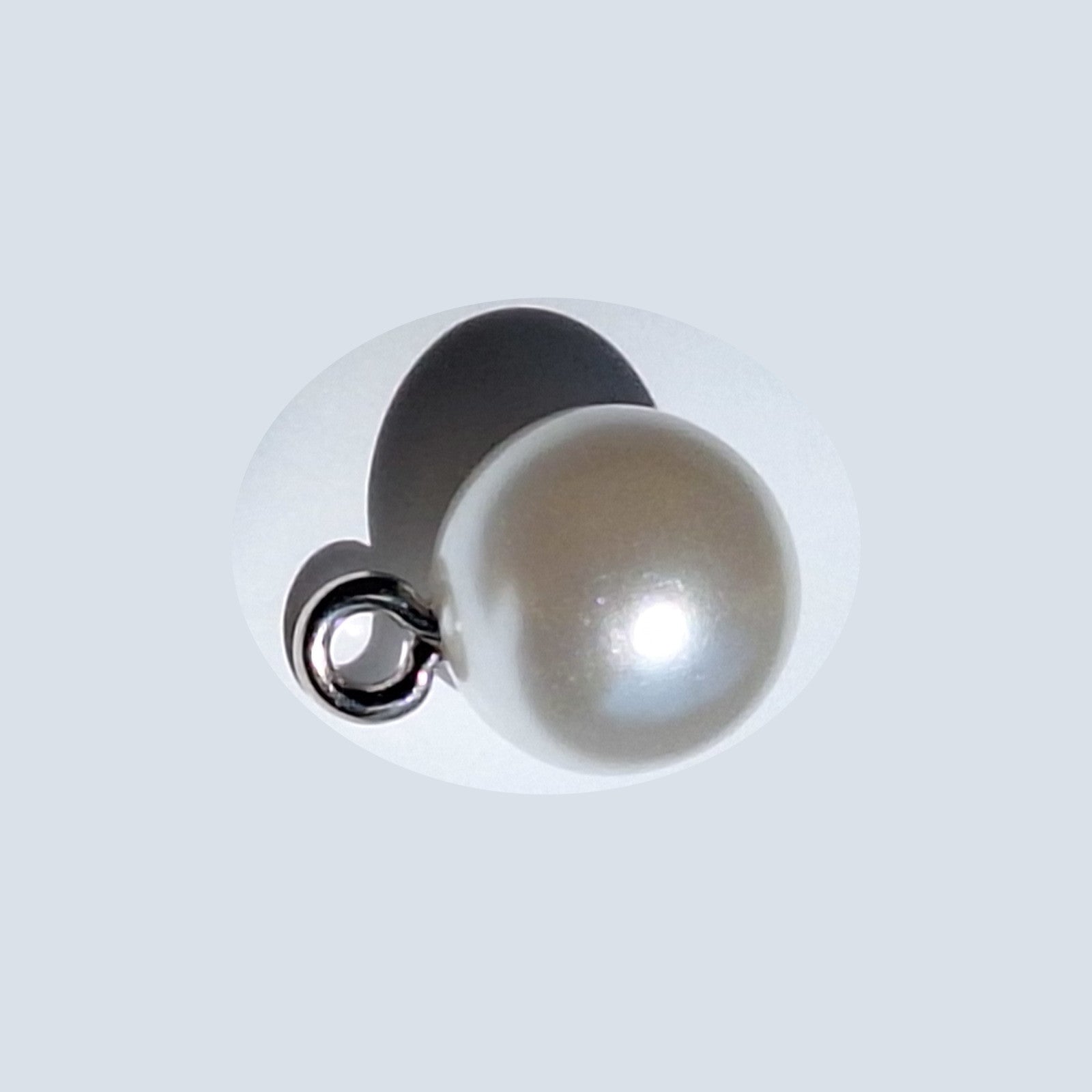 Pearlized full ball button with reflective finish and screw shank, shown in close-up for detail, 10mm.