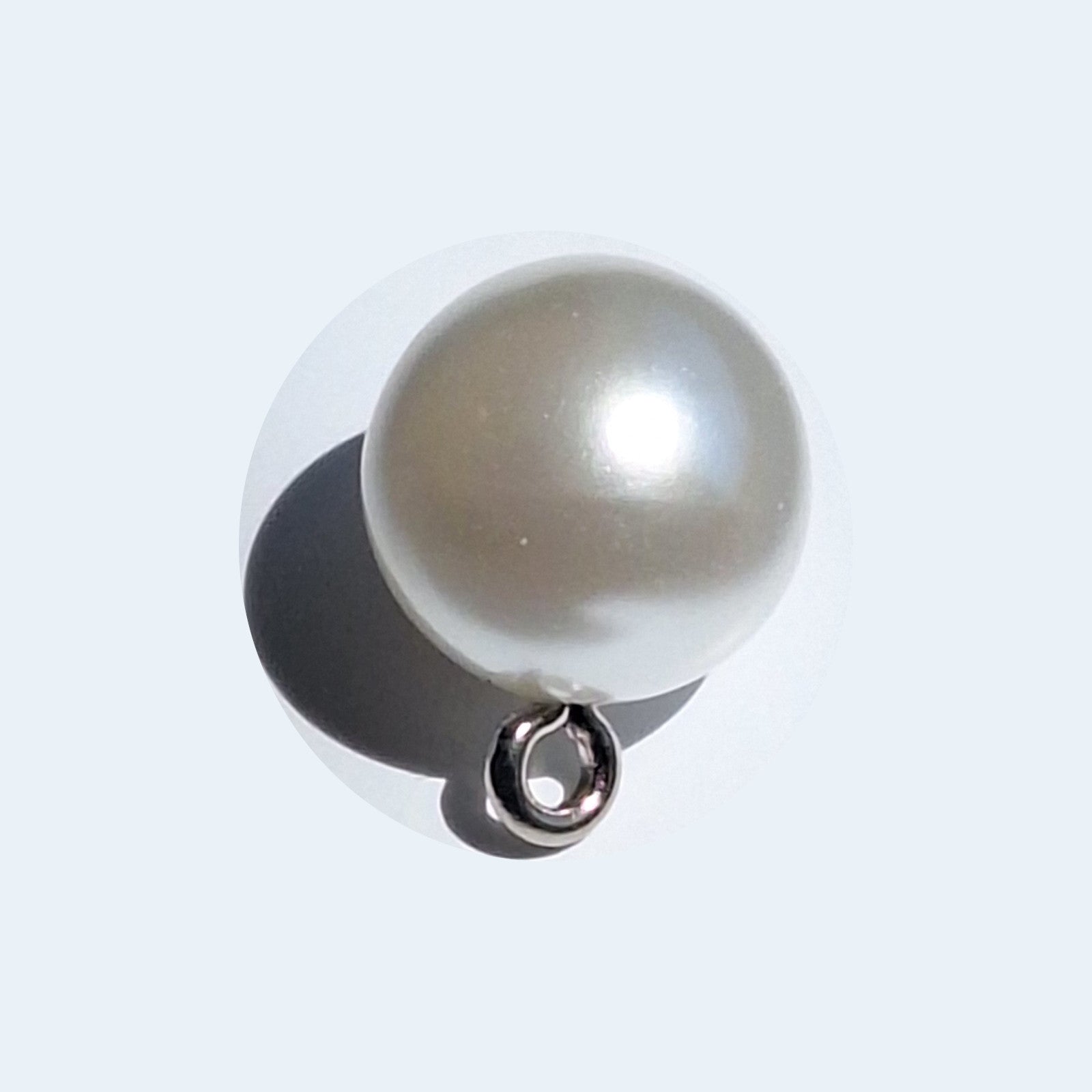 Pearlized full ball button with reflective finish and screw shank, shown in close-up for detail, 12mm.