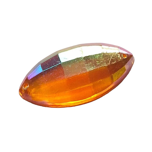 Topaz faceted plastic navette cabochon, 30x1 5 mm, with an iridescent finish.