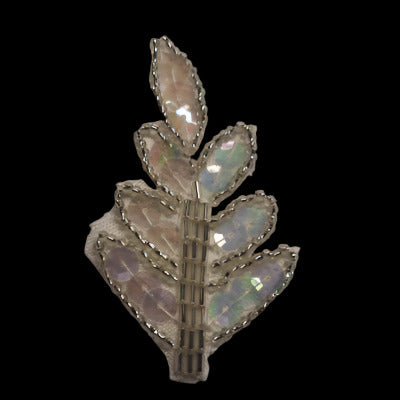 Tree-shaped applique with an outline of bugle beads and covered with iridescent sequins, on a black background