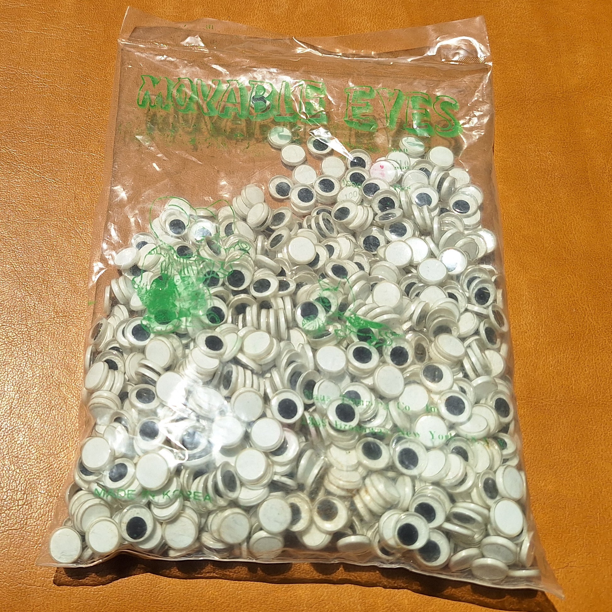 Bag of 1000 10mm plastic moveable flat back eyes from Korea.