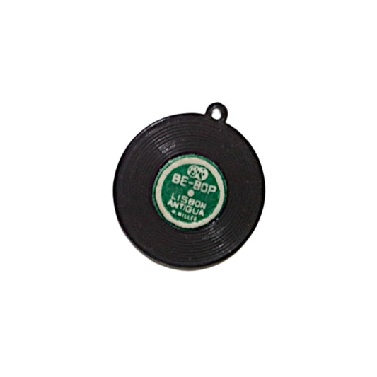 19mm black plastic record charm with grooves and assorted single-color labels on both sides.
