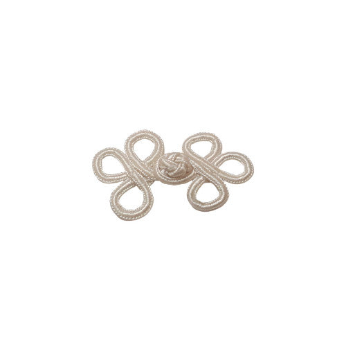 A white soutache frog closure with looped cord construction measuring 57×38mm.