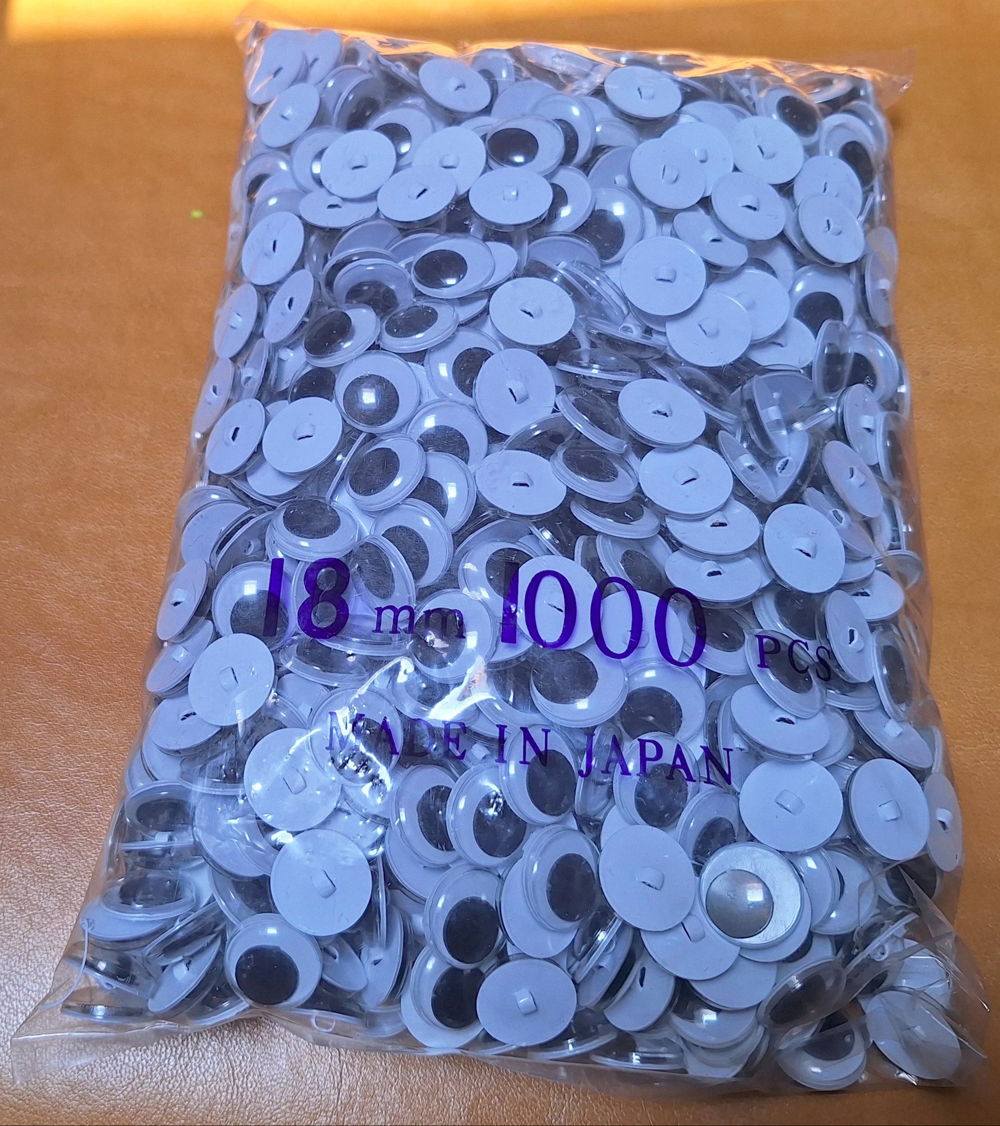 Bag of 1,000 18mm sew-on googly eyes with plastic shanks. Made in Japan.