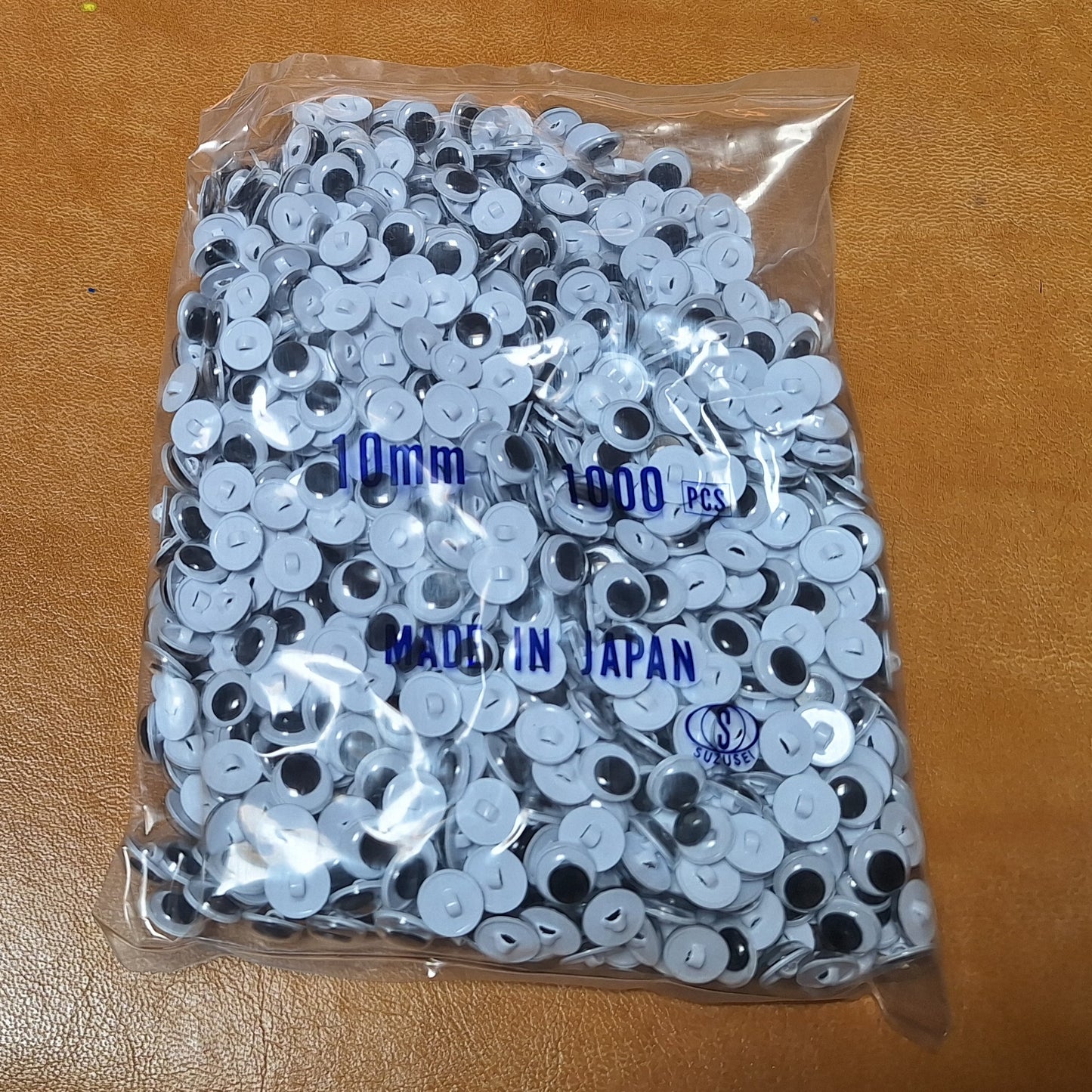 Bag of 1,000 10mm sew-on googly eyes with plastic shanks. Made in Japan.