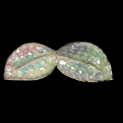 Large bow-shaped applique with an outline of bugle beads and covered with iridescent sequins, on a black background