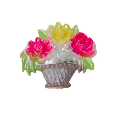 Plastic flat back of a flower basket with pink and yellow flowers on a white background