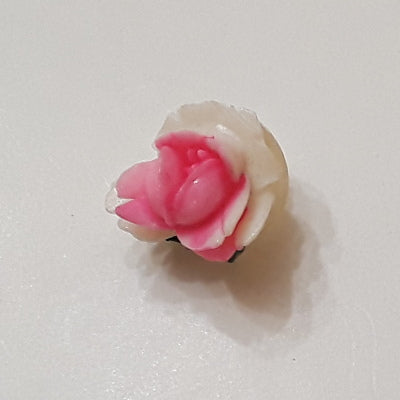 Small pink and white raised rose button showing the sculpted floral form from the front, highlighting the dimensional hand-painted petals.