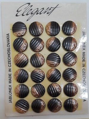 Button card of 24 28L Ribbed glass buttons with gold colored embossed flowers on one half