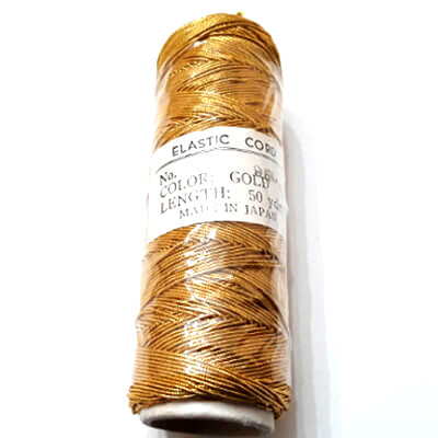 Gold elastic cord wound on a 50-yard spool