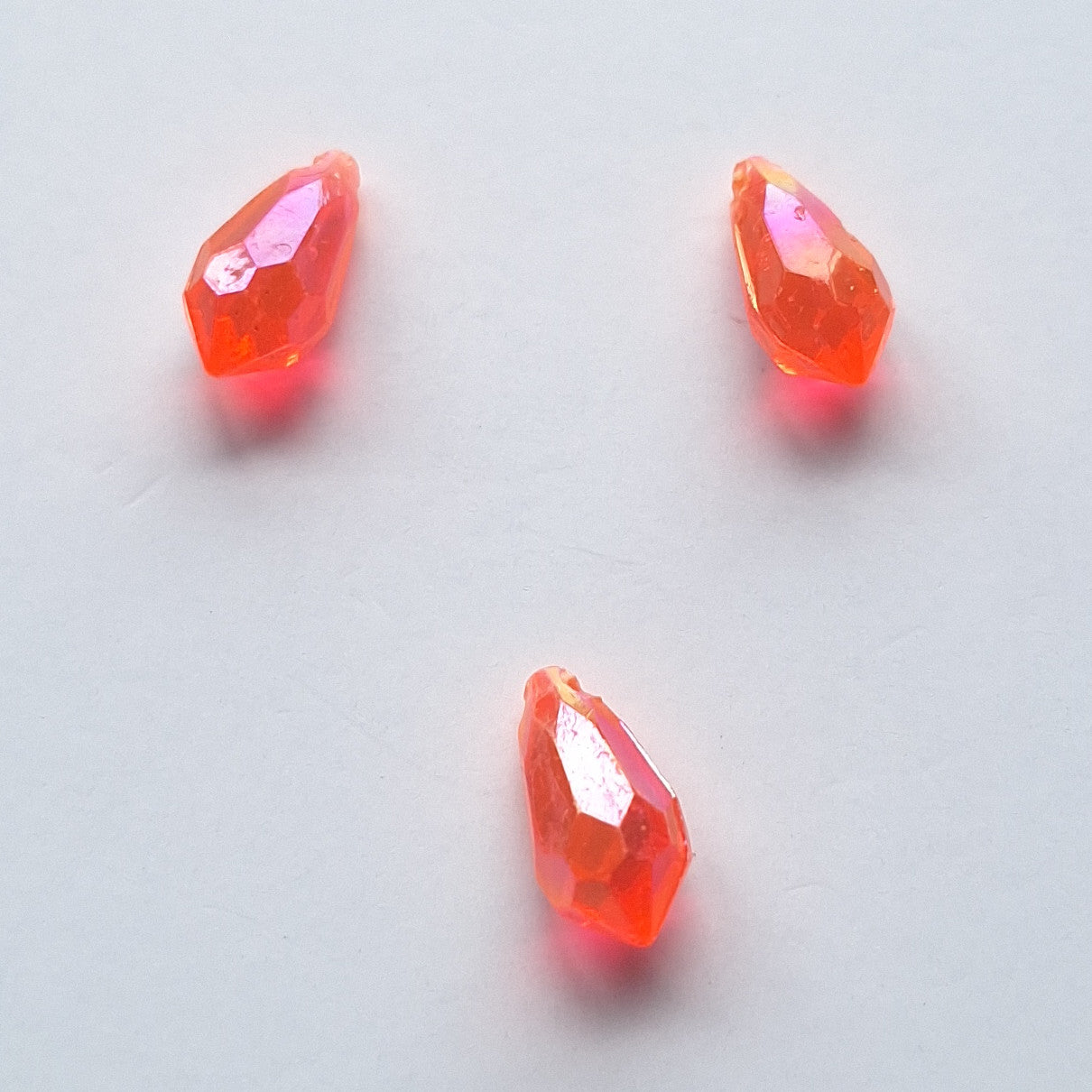 Three AB faceted plastic drop in Coral, translucent, sew-on, 6.5x13mm.