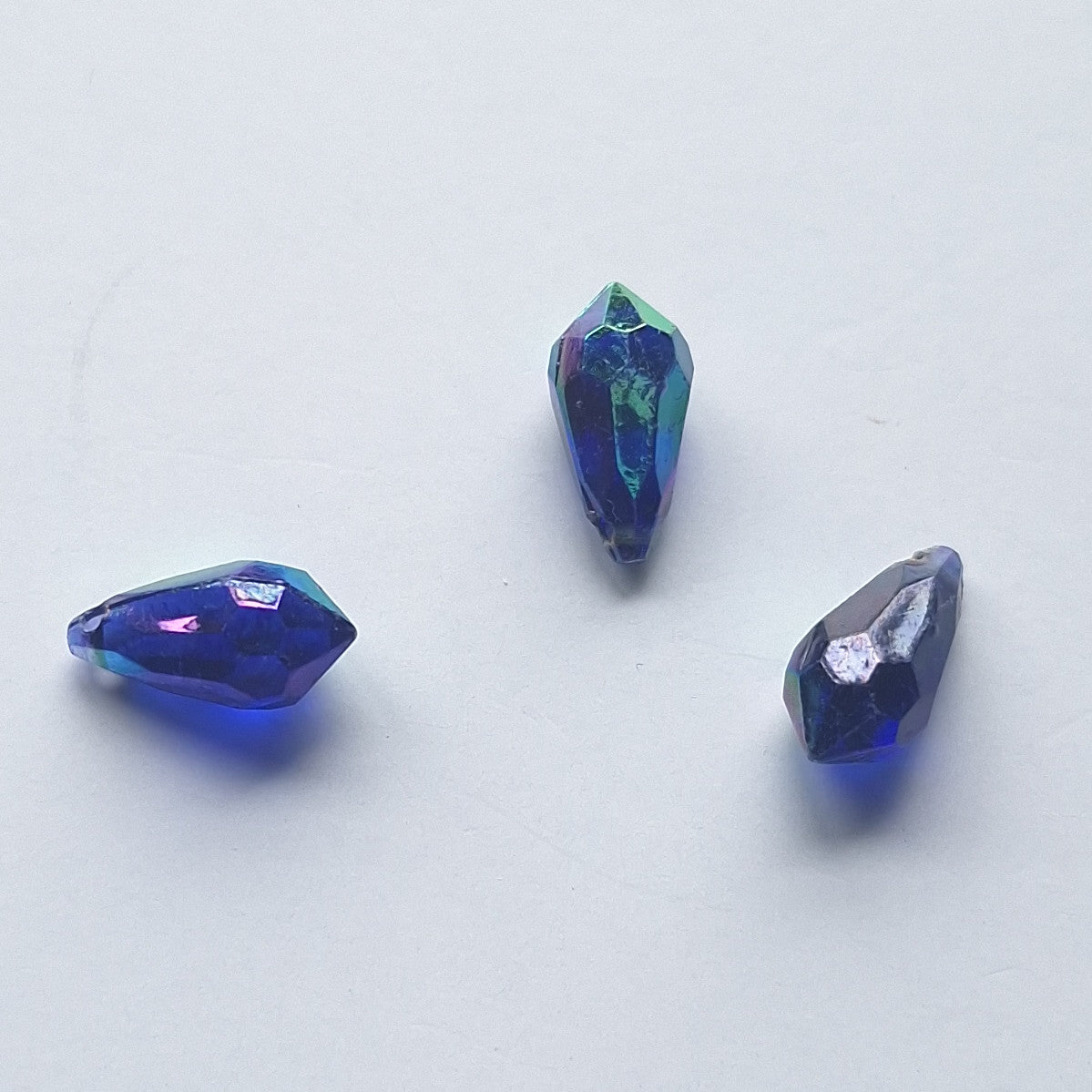 Three AB faceted plastic drop in Midnight Blue, translucent, sew-on, 6.5x13mm.