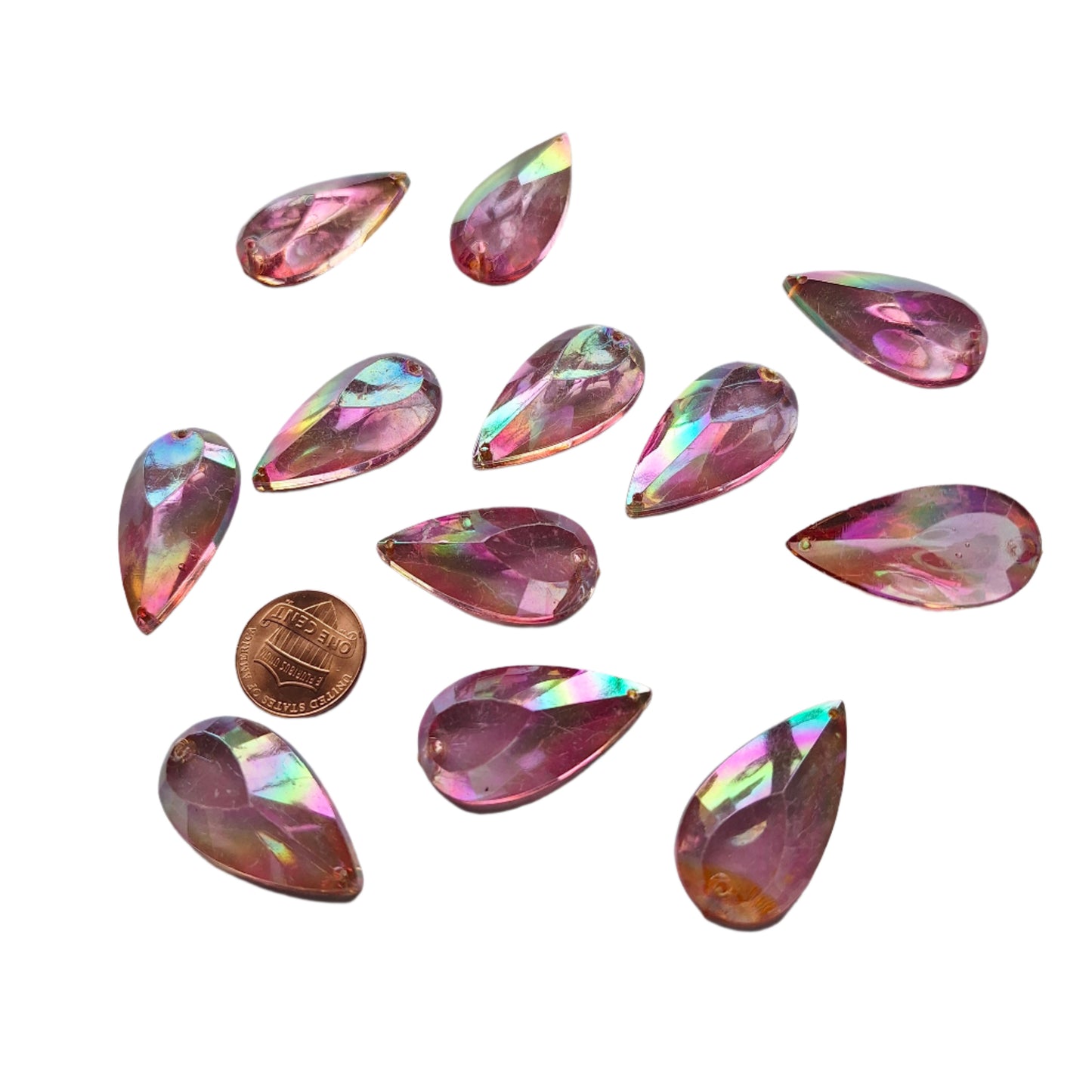Amethyst AB teardrop cabochons shown together, with a penny for scale.